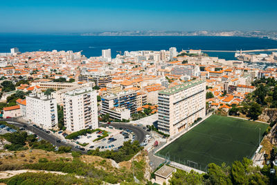 High angle view of buildings and sea against sky