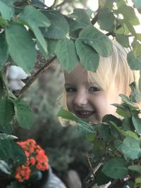 Close-up portrait of girl with plants