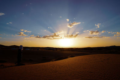 Scenic view of desert against sky during sunset