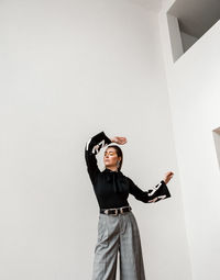 Woman standing against wall