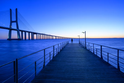 Pier over sea against clear sky