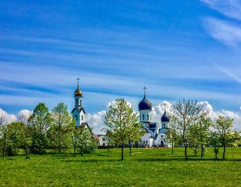 View of trees and building against sky
