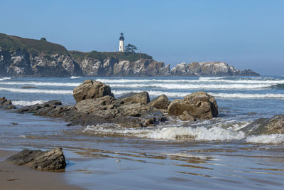 Rocks on beach against sky