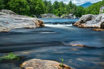 Scenic view of waterfall against sky