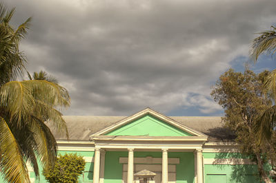Low angle view of building against cloudy sky
