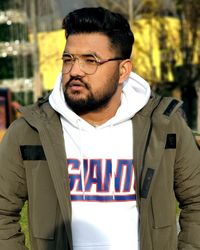 Portrait of young man standing outdoors