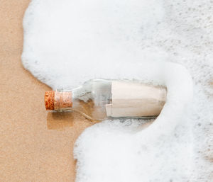 High angle view of ice on table against white background