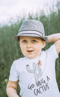 Portrait of boy wearing hat standing outdoors