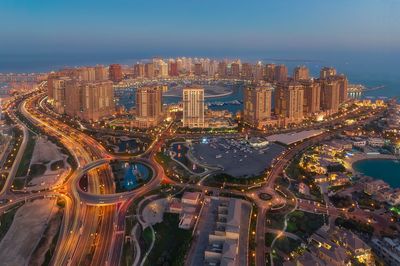 High angle view of city lit up at night