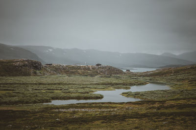 Scenic view of lake and mountains against sky