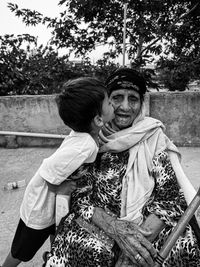 Portrait of couple sitting outdoors