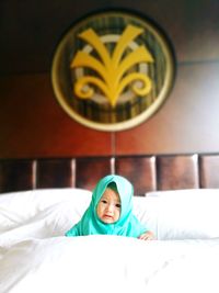 Portrait of boy lying on bed