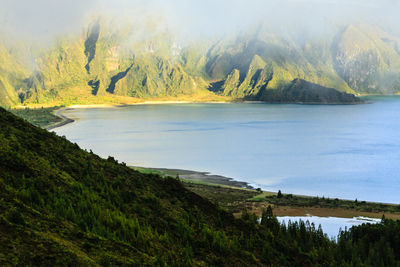 Scenic view of lake and mountains against sky