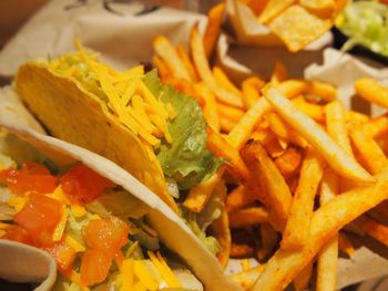 High angle view of tacos and french fries in plate