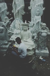 Statue of buddha against building