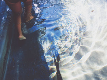 Low section of woman in swimming pool