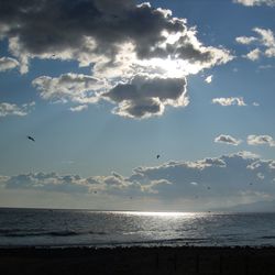 Scenic view of sea against cloudy sky