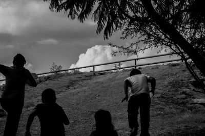 Man standing by tree