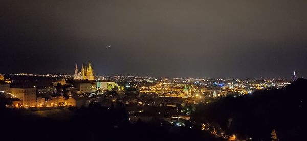 High angle view of illuminated buildings against sky at night