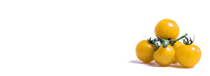 Close-up of yellow fruits on white background