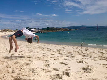 Full length of man on beach against sky