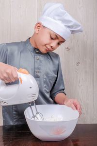 Boy preparing food in kitchen