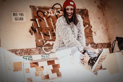 Portrait of smiling young woman standing at home