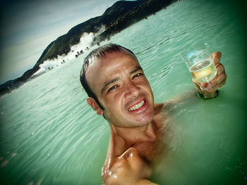 Portrait of young man swimming in pool