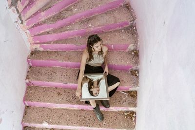 Low section of woman sitting on staircase