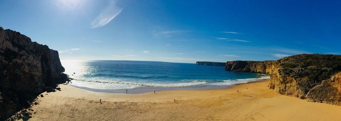 Panoramic view of beach against blue sky