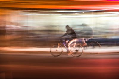 Blurred motion of man cycling at night