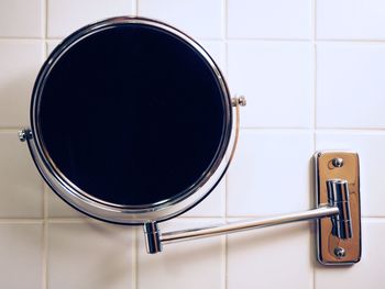 Mirror with reflection on bathroom wall