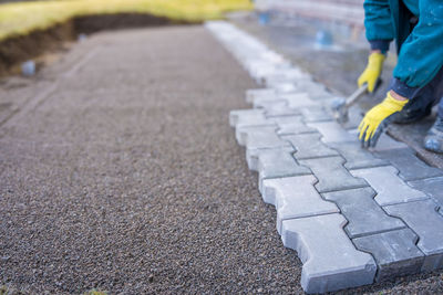 Low section of man walking on road