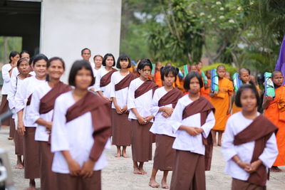 Group of people standing in row