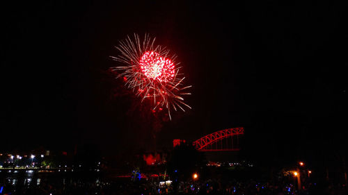 Low angle view of firework display in sky at night