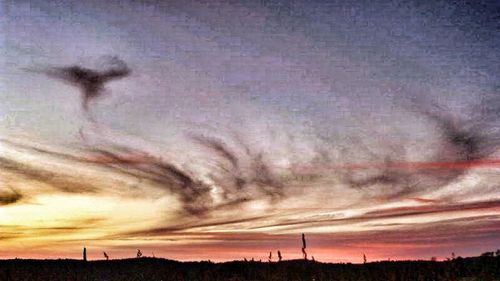 Scenic view of landscape against cloudy sky