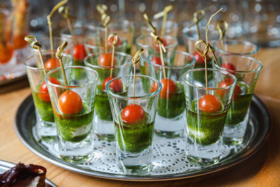 Caprese appetizer canape in glasses - catering, food and drink, holidays and celebration concept