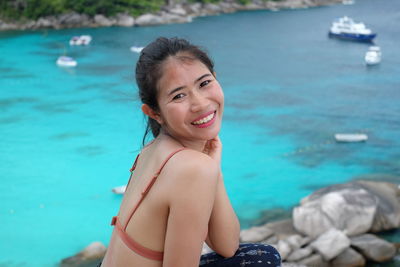 Portrait of young woman swimming in sea