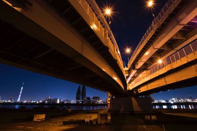 Low angle view of illuminated bridge at night