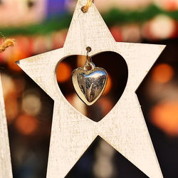 Close-up of heart shape decoration hanging on paper