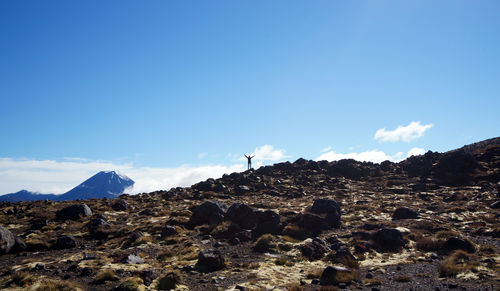 Scenic view of mountains against blue sky