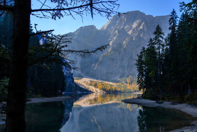 Scenic view of lake and mountains against sky during winter