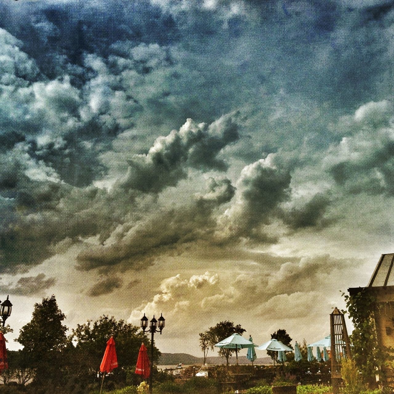 sky, cloud - sky, cloudy, low angle view, weather, cloud, built structure, building exterior, architecture, overcast, tree, storm cloud, outdoors, dramatic sky, nature, cloudscape, day, no people, house, beauty in nature