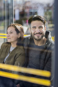 Mid adult couple on bus stop