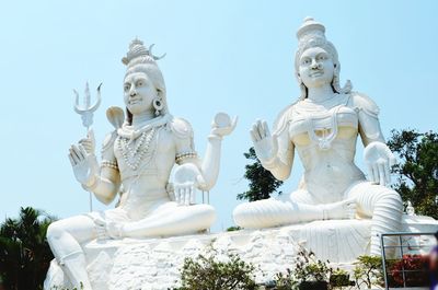 Low angle view of statue against temple