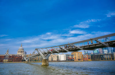 Bridge over river with buildings in background