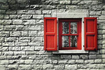 Red window on brick wall