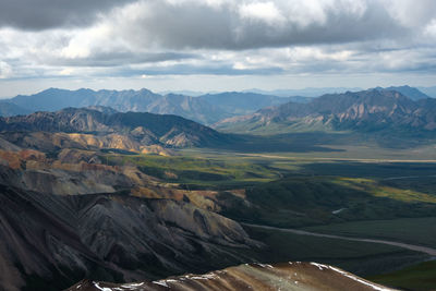 Scenic view of mountains against cloudy sky