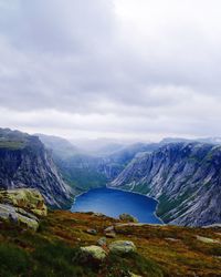 Scenic view of mountains against cloudy sky