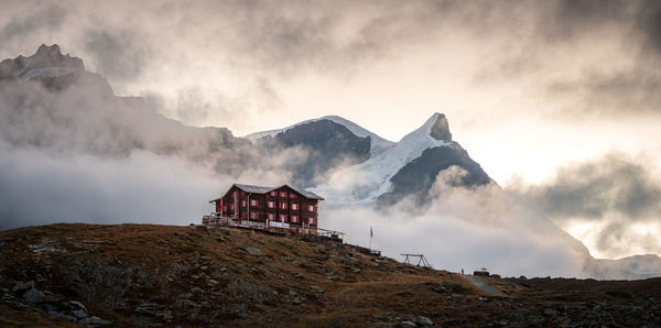 Old hotel above zermatt. peak of mount adlerhorn covered by glacier.